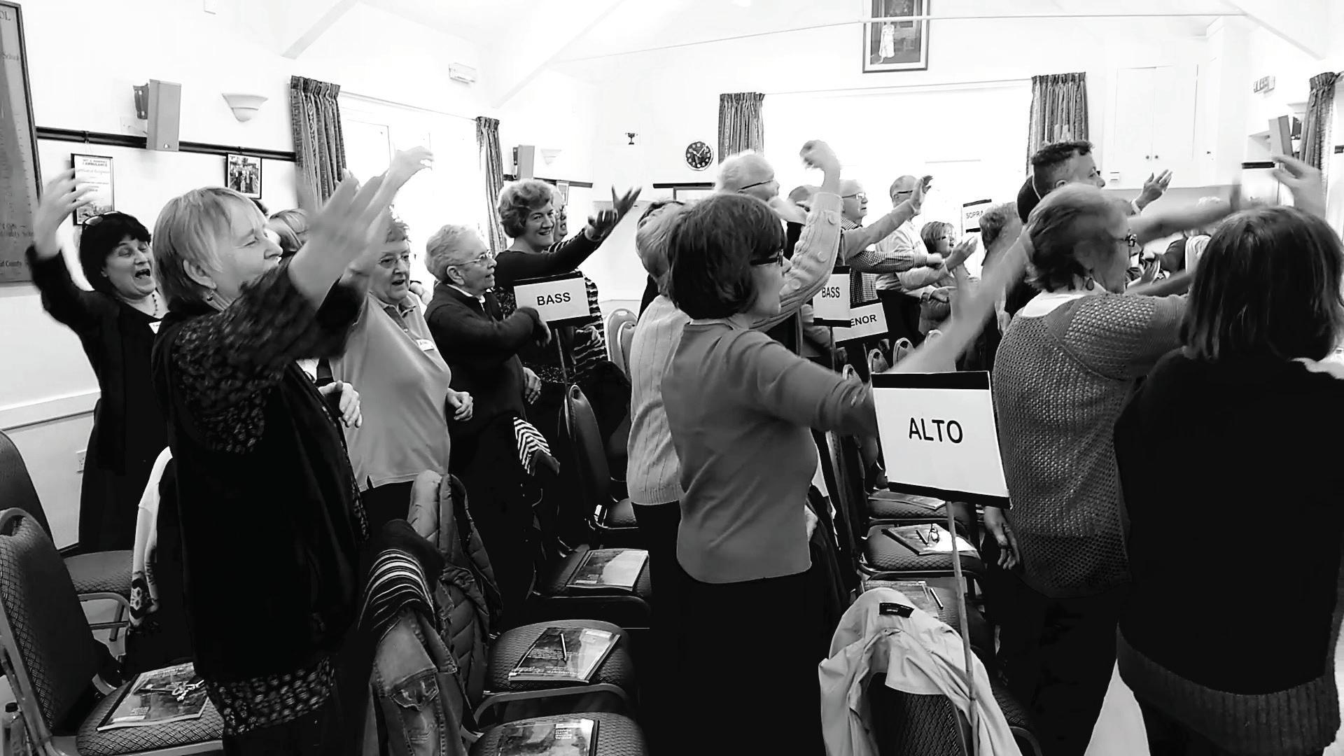 The choir doing warm ups in rehearsal.